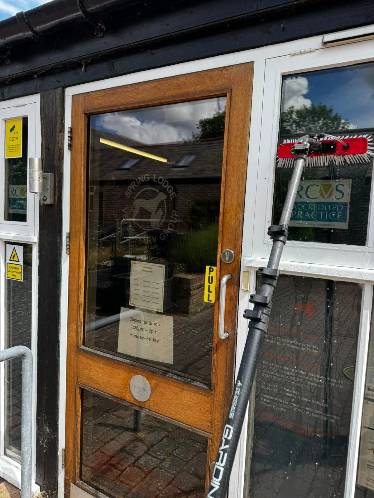 Water-fed pole cleaning the entrance glass at Spring Lodge Veterinary Group